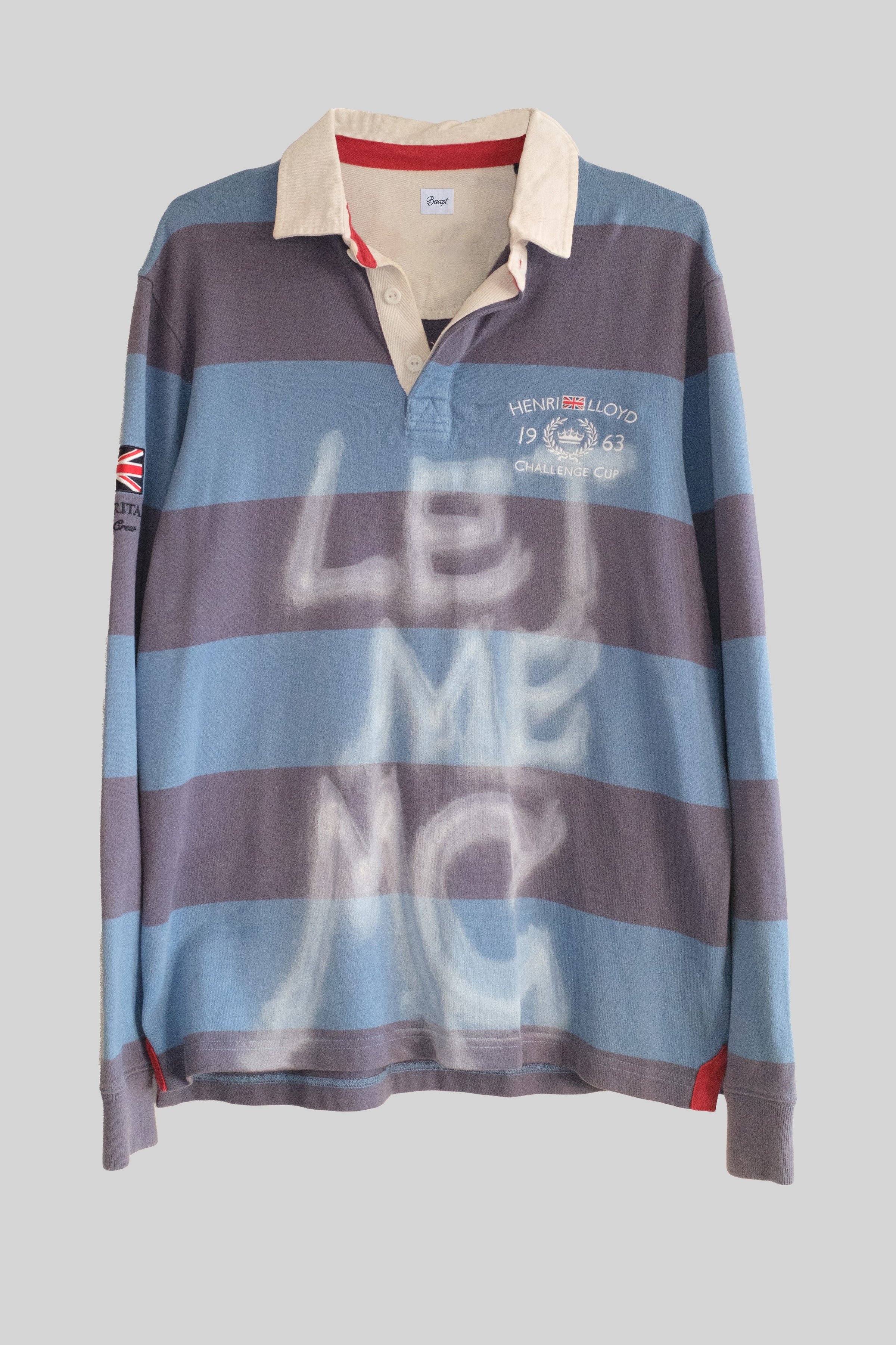 Striped long-sleeve shirt with 'LET ME MC' text on a gray background