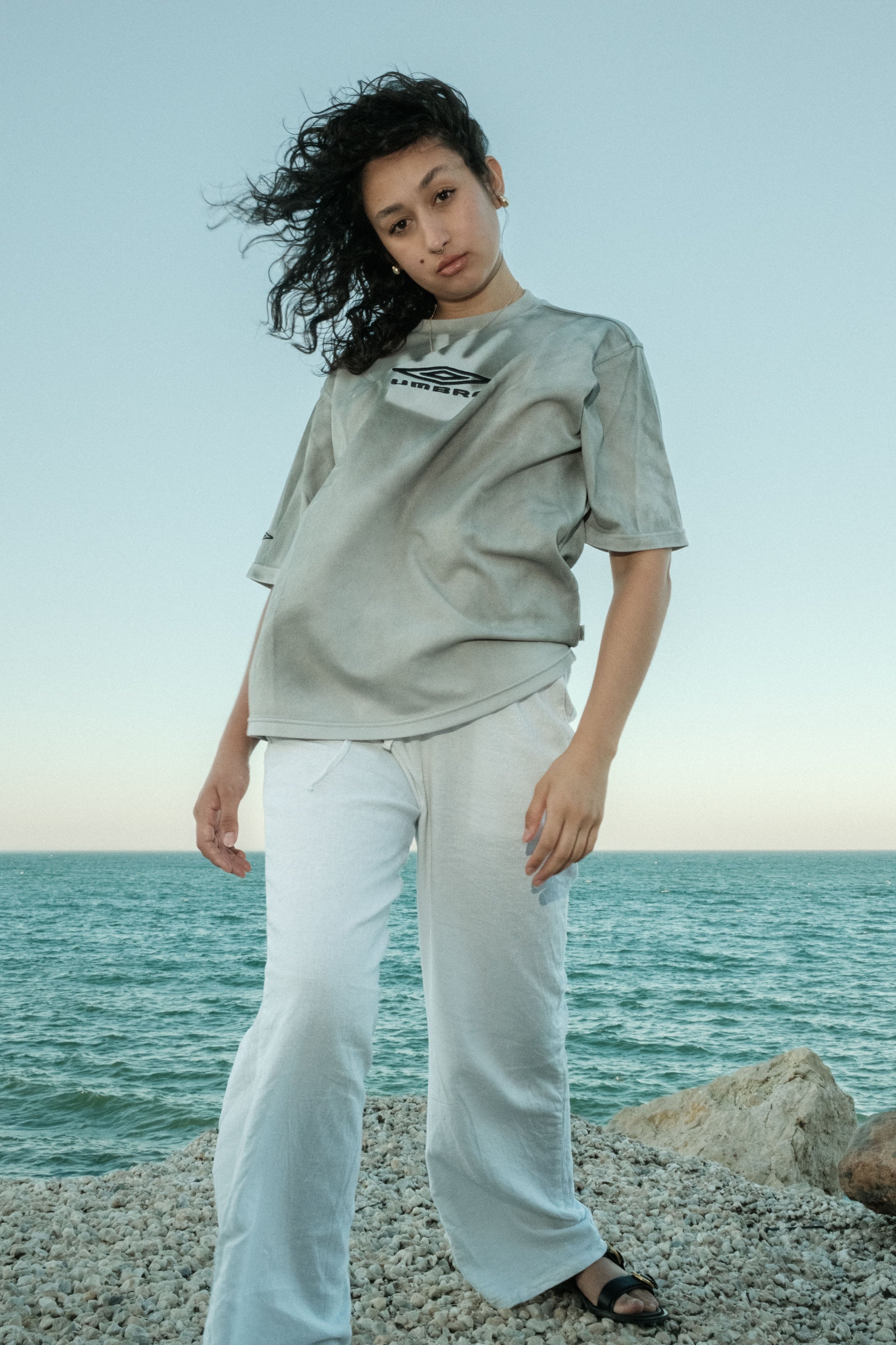 Grey reworked t-shirt styled with white trousers by the sea, Bewept Bag of Man collection.