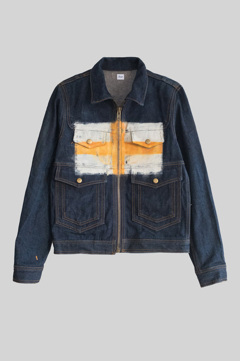 Denim jacket with a colorful patch on a gray background